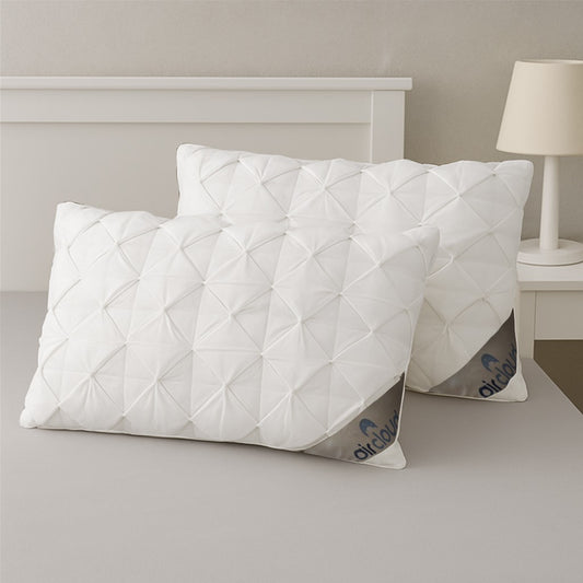 Two white quilted waffle pillows on a bed